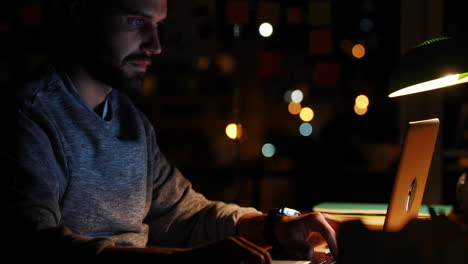 casual businessman using laptop at night