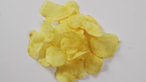 close up of potato chips with copy space on white surface