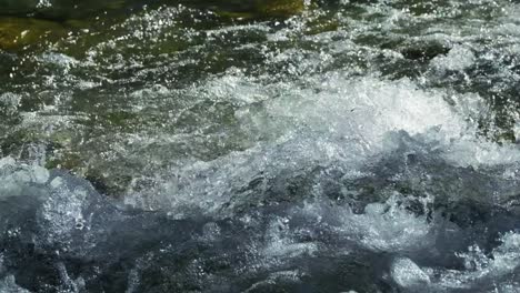 Cerca-De-Salpicaduras-De-Agua-Que-Fluye-Desde-El-Río-De-La-Montaña-En-El-Día-De-Verano