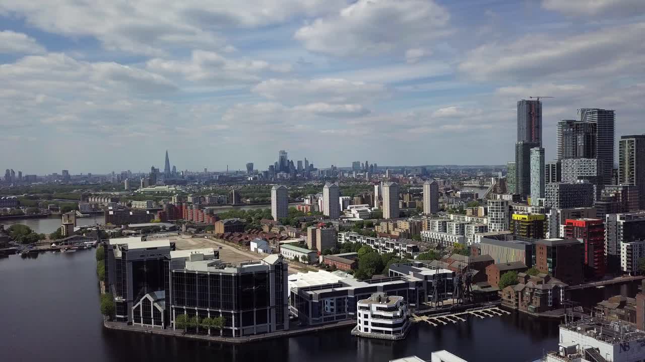 Aerial drone view of River Thames and Canary Wharf of London during day as the camera pans to right