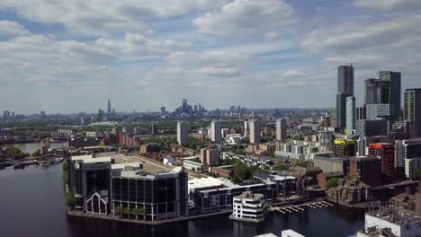 aerial drone view of river thames and canary wharf of london during day as the camera pans to right