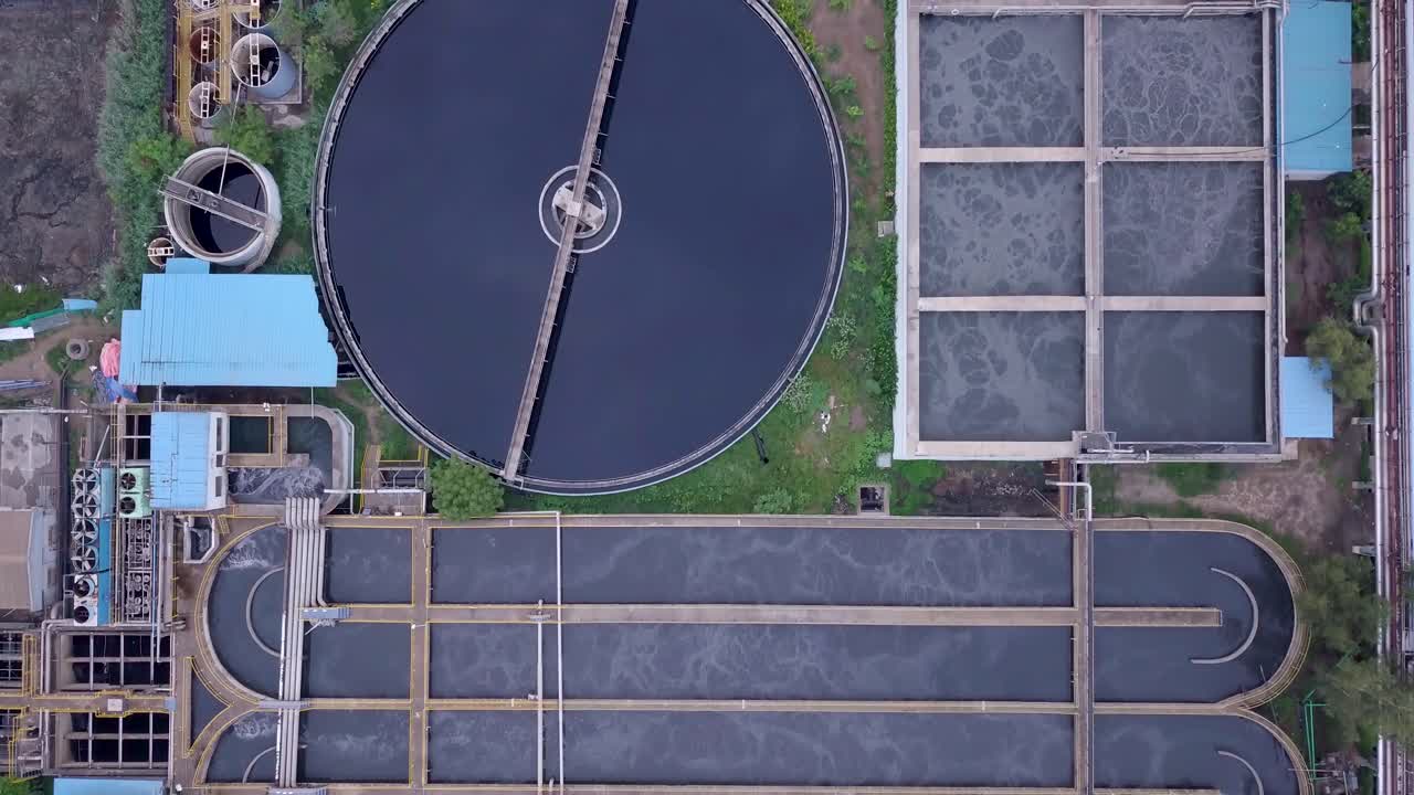 Top down aerial view of Industrial wastewater cleaning infrastructure in Gujarat, India. Drone view above water pool tanks station for purified drinking water supply.