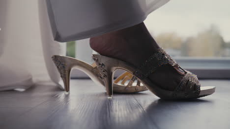 bride wears heeled sandals with gemstones