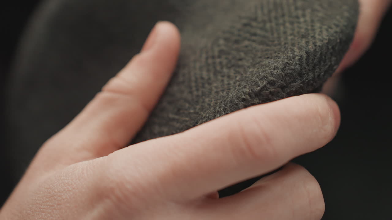 Careful review of textile quality. Precise inspection of cloth textures and stitching details by artist. Artist conducts thorough and detailed examination of fabric textures and quality