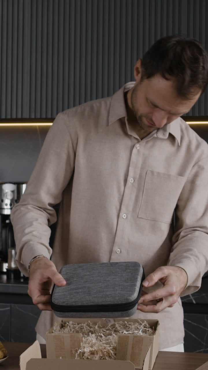 Man unboxing a package in the kitchen