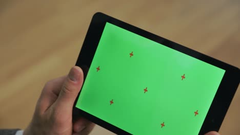 Männliche-Hände-Halten-E-Book-Mit-Grünem-Bildschirm.-Nahaufnahme-Eines-Tablets-Mit-Chromakey-Bildschirm