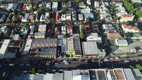 High-speed-aerial-perspective-showing-traffic-banking-up-at-inner-city-t-intersection