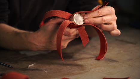 artisan crafting red leather item