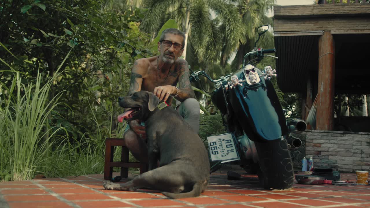 Man and his dog near a motorcycle