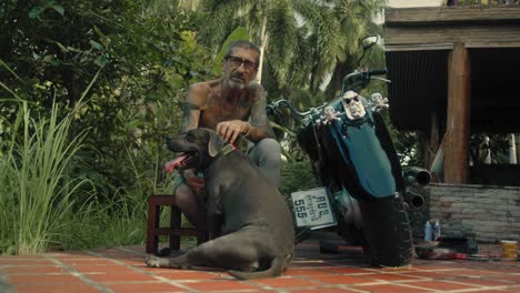 man and his dog near a motorcycle