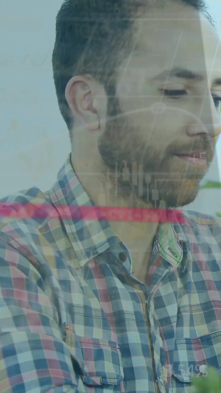 Video verticale: Uomo che si gira e guarda in basso a destra, avvia grafici finanziari per esaminare i dati.