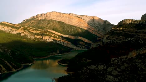 water flowing between two mountain ridges, green vegetation cover over foot of the mountain ridges in barcelona