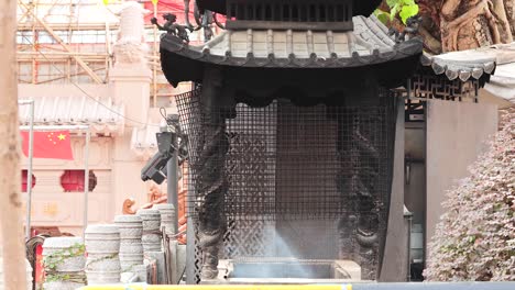 smoke rises from incense at hong kong temple