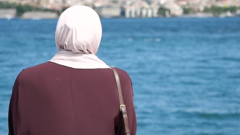 woman in hijab by the sea