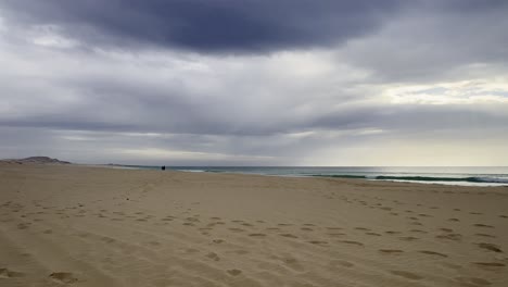 couple walking on a stormy beach