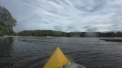 experience tranquil kayaking on hamble river's serene waters. quaint scenery under a gentle cloudy sky, with rich greenery framing the tranquil horizon. no people present