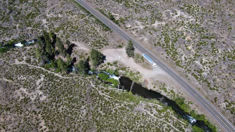 toma aérea de una carretera junto con pinos en el bosque nacional de lassen