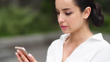 chica de primer plano usando teléfono móvil al aire libre. mujer de negocios usando teléfono después del trabajo