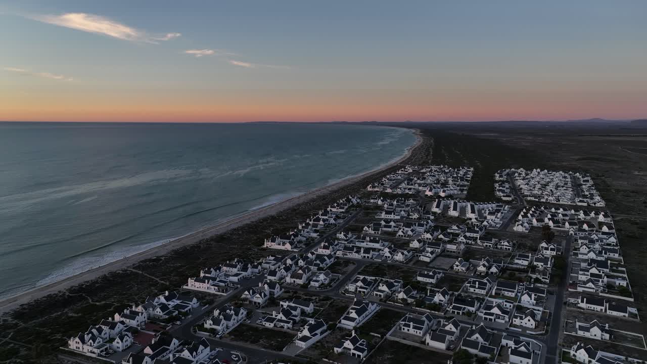 Aerial flyover of Dwarskersbos municipality on Africa desert coastline