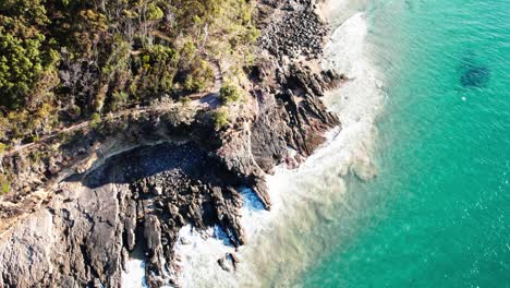 rocky cliffs and ocean in noosa shire, queensland, australia - drone shot