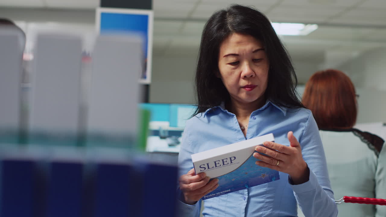 Woman looking at sleep product in pharmacy