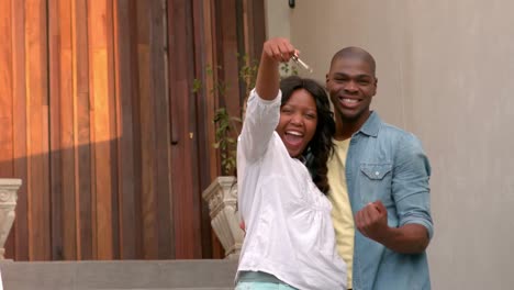 Happy-couple-outside-their-new-home