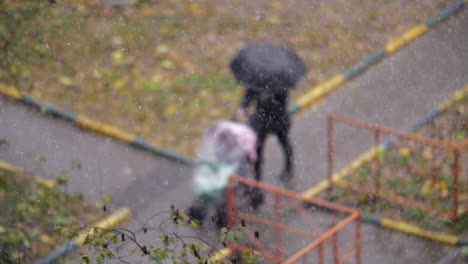 woman with child outside on snowy autumn day