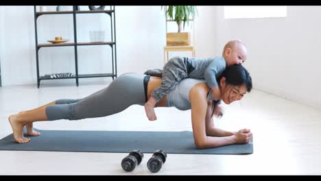 mother and baby doing plank exercise at home