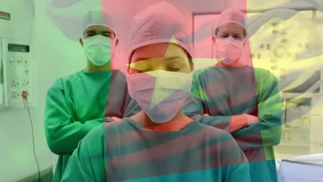 Animation-of-flag-of-cameroon-waving-over-surgeons-in-face-masks