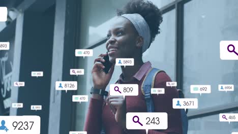 animation of social media icons with growing numbers over african american woman using smartphone