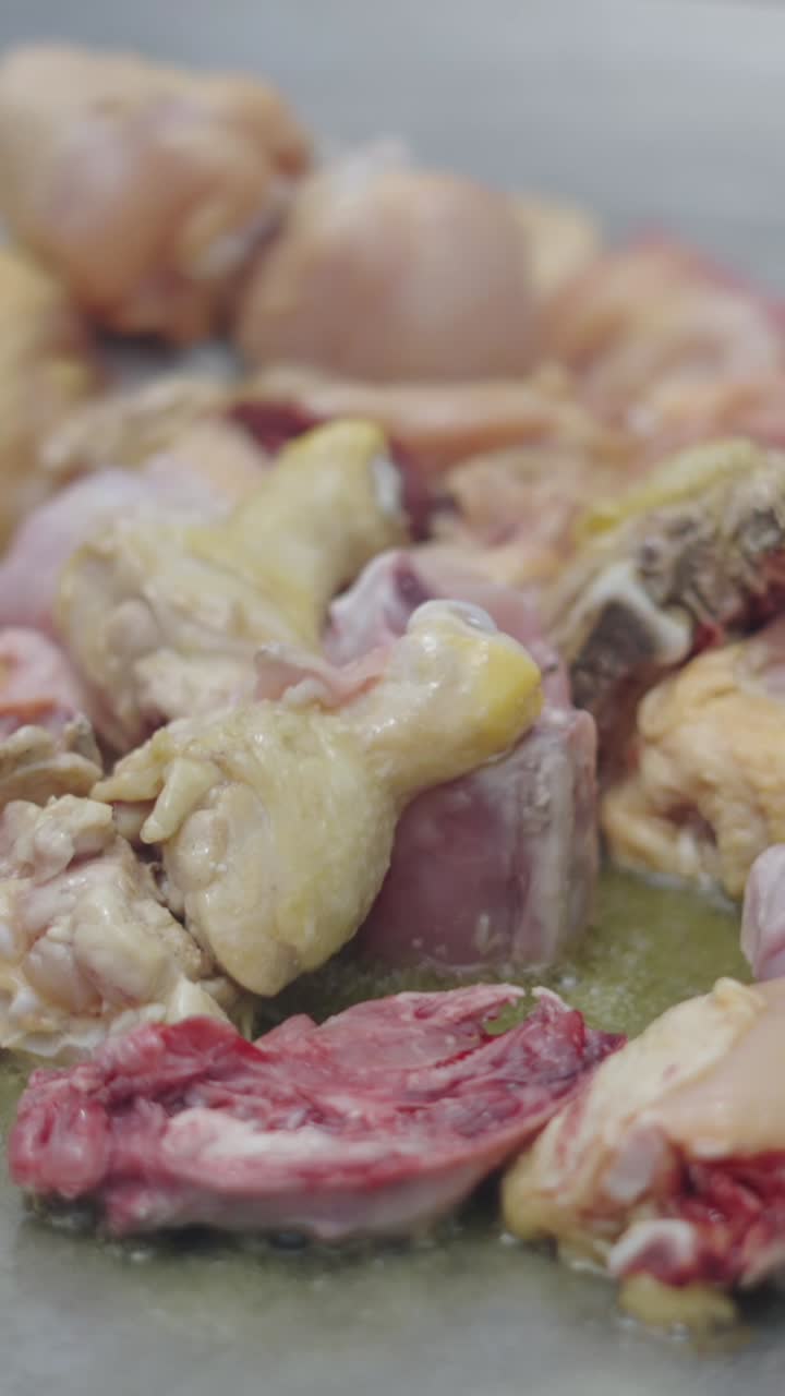 Raw Chicken Pieces Cooking in a Pan