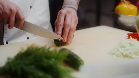 chef chopping cucumber