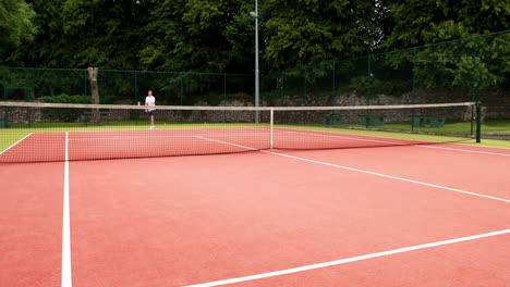 young tennis player serving the ball