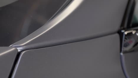 detail of car body exterior after wrapping with grey xpel foil