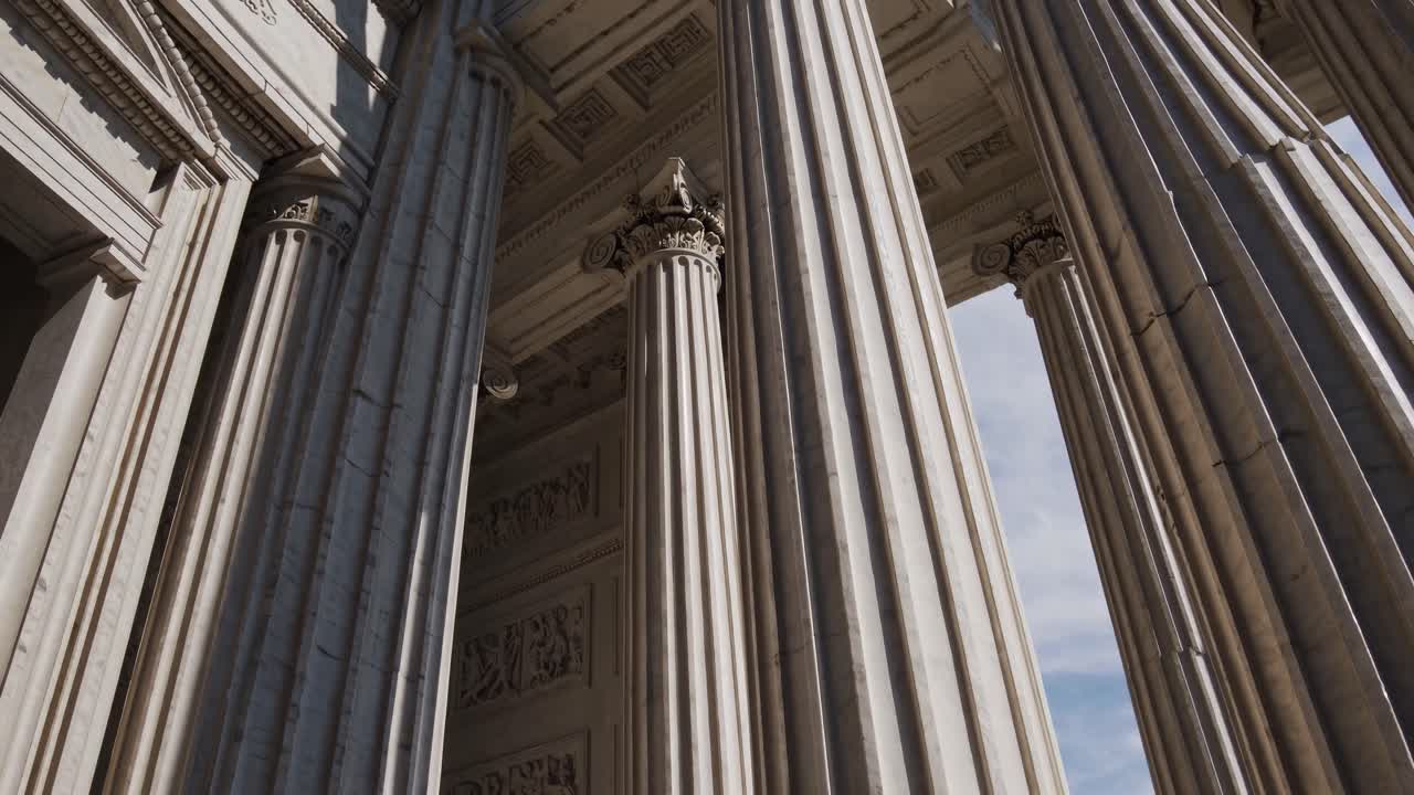 Low-angle video shot of grand architectural columns, showcasing intricate details and classical