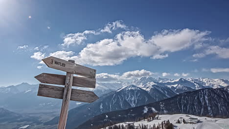 wooden sign post arrow pointing to watles ski resort in south tyrol, italy in winter