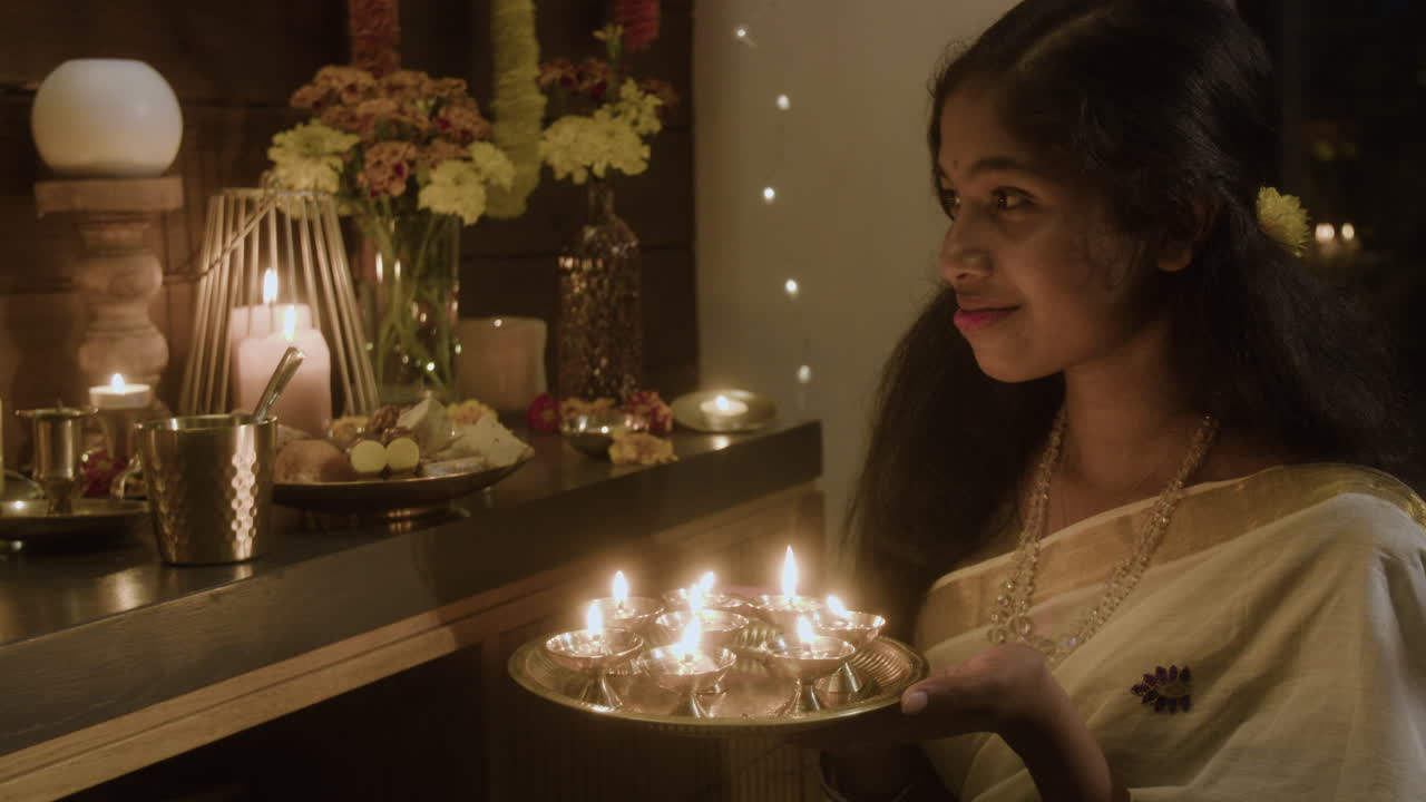 Indian woman celebrating Diwali with candles