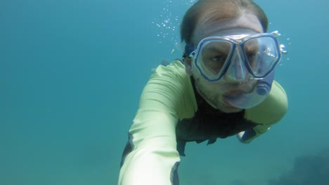 freediver exploring the ocean, handheld selfie shot