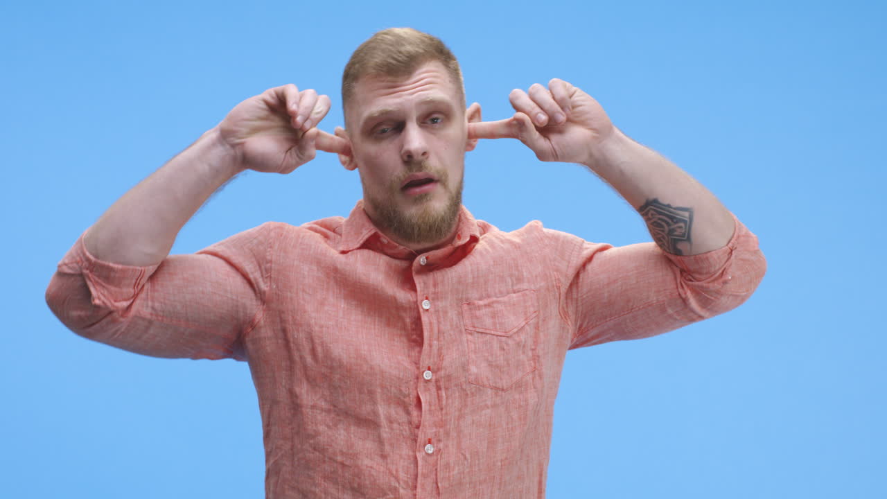Man covering ears with his hands