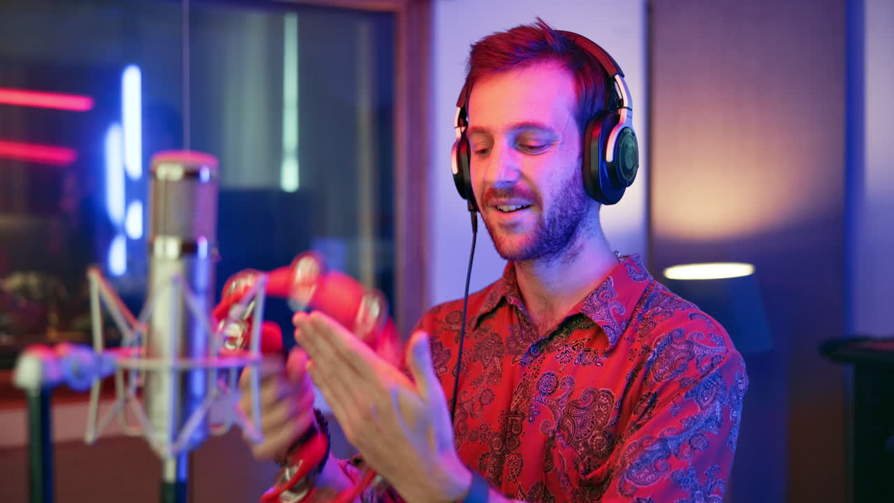 Man playing tambourine in music studio