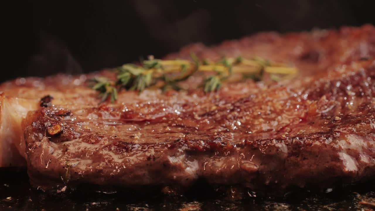 Fresh marbled beef with pepper, salt and rosemary close-up macro. Cooking juicy steak on grill with oil. Premium organic wagyu meat. High quality 4k footage