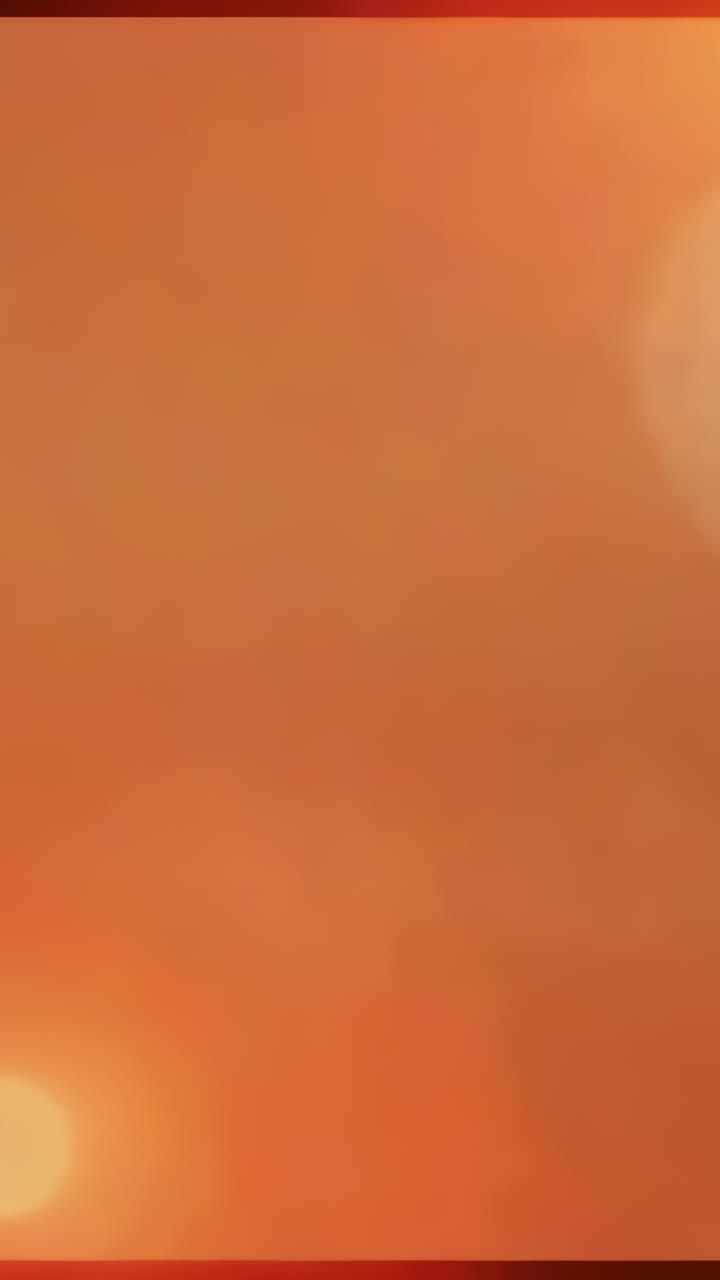 Vertical video: Displaying abstract backdrop shimmering across frame, showing glowing bokeh circles