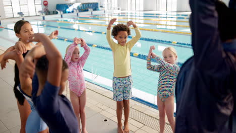children stretching before swimming at the pool