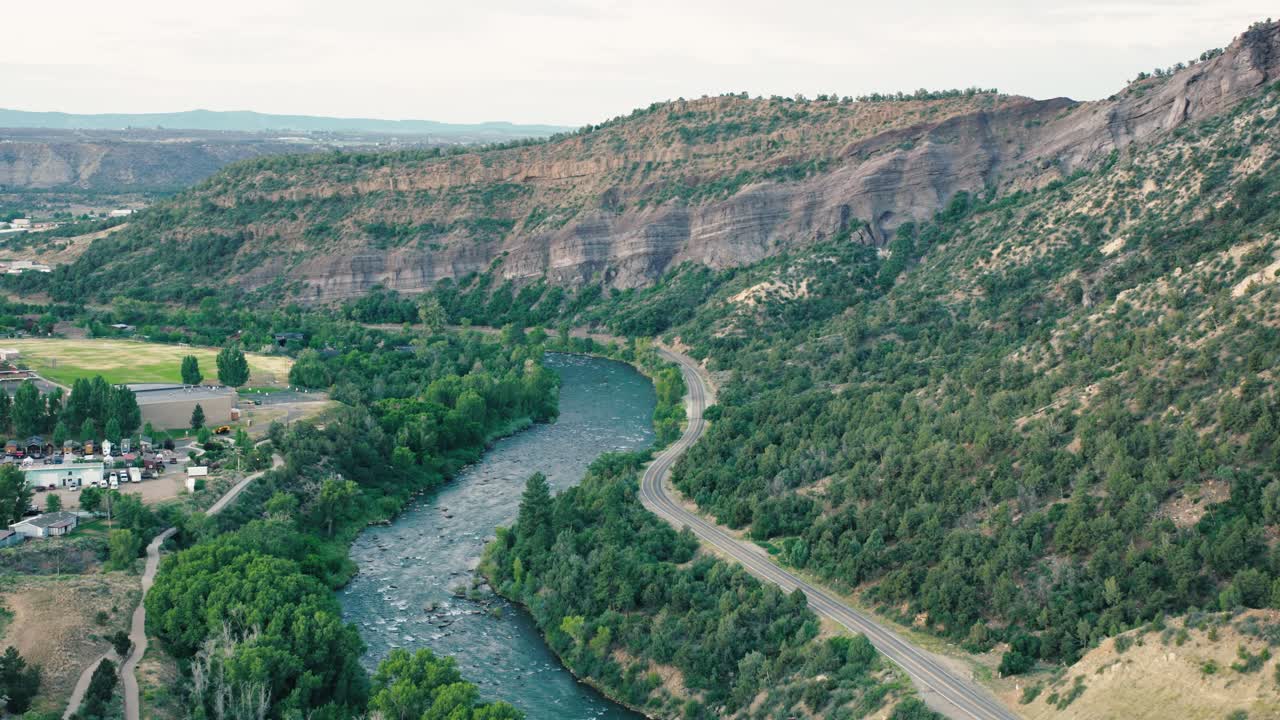 Tracking shot that follows a bend in the river, revealing both urban and natural beauty coexisting in Durango.