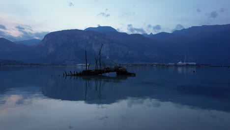 drone-fly-above-ocean-water-in-Squamish-River-restricted-conservation-area-Canada,-natural-scenic-landscape-with-wooden-islet-tree-trunk