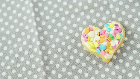 Decorated-heart-shape-cookie-against-polka-dot-background