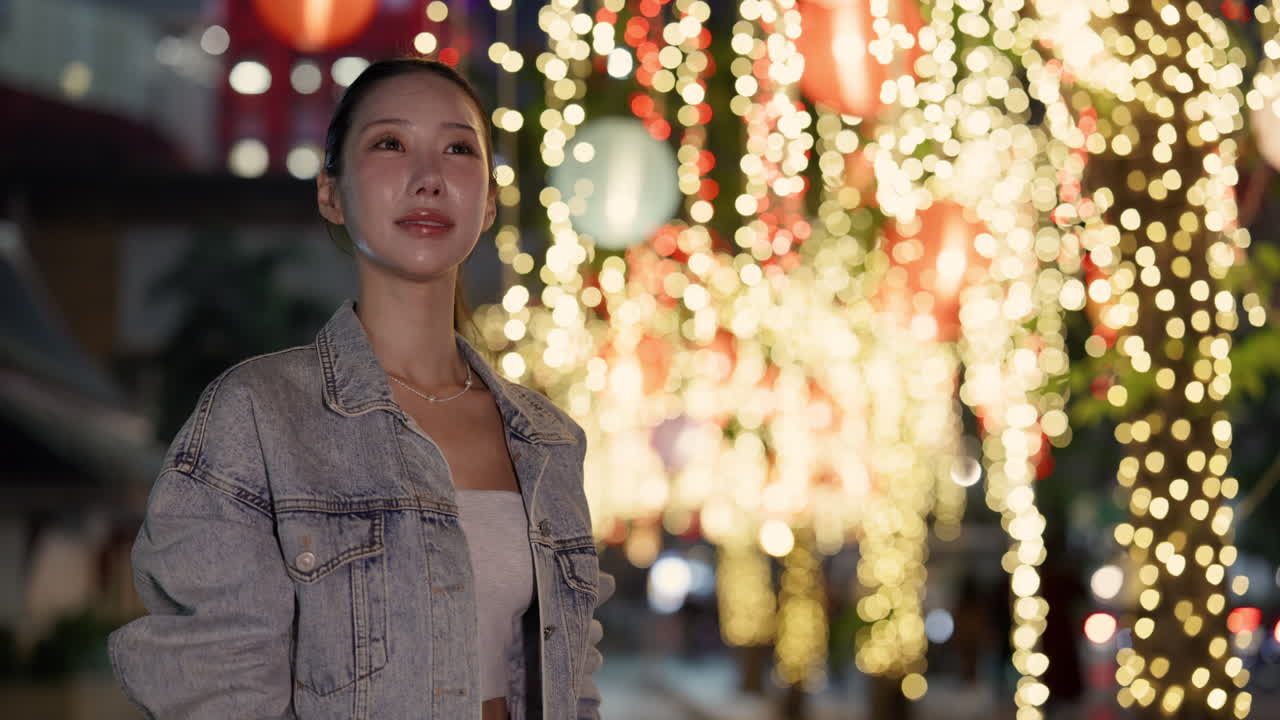 Woman enjoying city lights at night