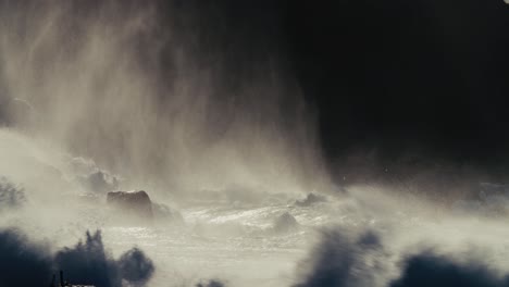 ocean waves roll into a rocky shore in slow motion