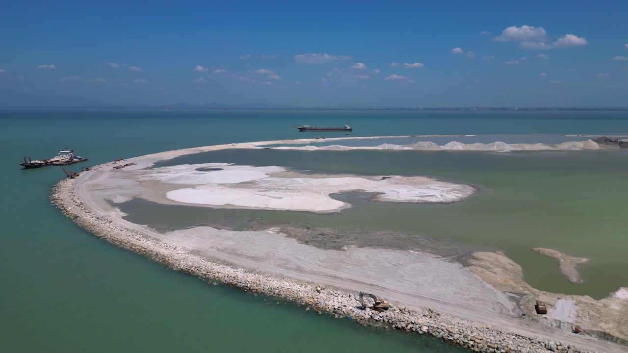 Land reclamation project in Penang creating new land from the sea, showing environmental impact and coastal urbanization. Magic aerial view static panorama hovering drone