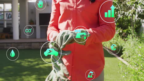 woman pulling gardening gloves on lawn, showing environmental icons tracking co2 energy metrics